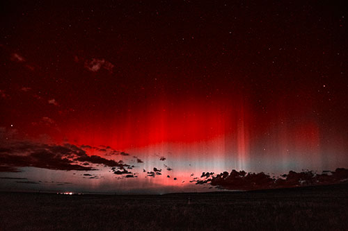 Northern Aurora Borealis Lights Up Night Sky (Red Tone Photo)